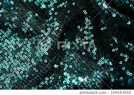 Christmas abstract background made of emerald green sequins. Christmas abstract background made of emerald green sequins. 109583938