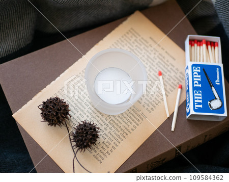Antique old books, candles, and nuts [Autumn] [Winter] 109584362