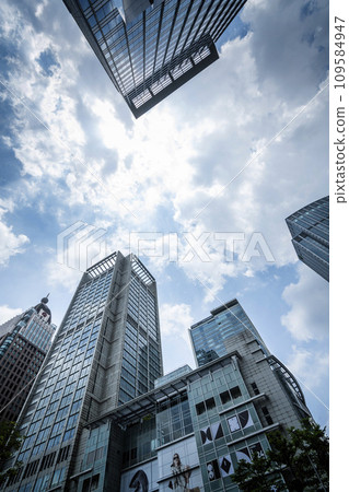 Low-angle view of modern buildings in Xinyi District, Taipei, Taiwan. the district is Taipei's main shopping area, anchored by several department stores and malls. 109584947