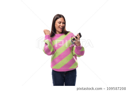 young slender caucasian woman with straight black hair dressed in a striped pink pullover young slender caucasian woman with straight black hair dressed in a striped pink pullover 109587208
