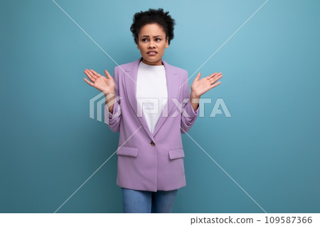 young successful hispanic brunette leader woman with curly hair dressed in a business suit 109587366