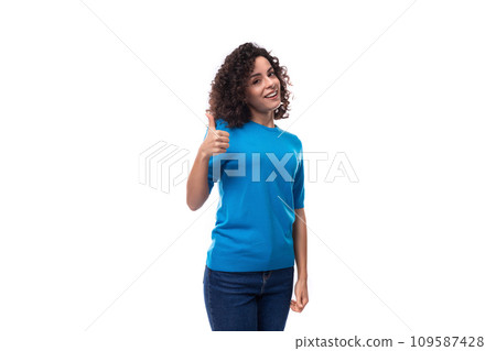 portrait of a young confident woman in a blue sweater with short sleeves on a white background 109587428