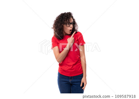 portrait young caucasian leader woman with black curly hair dressed in a red basic t-shirt portrait young caucasian leader woman with black curly hair dressed in a red basic t-shirt 109587918