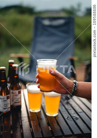 Beer on the table and camping party,hands toasting in beer, 109588886
