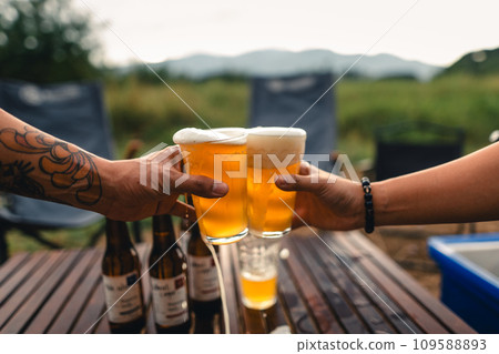 Beer on the table and camping party,hands toasting in beer, 109588893
