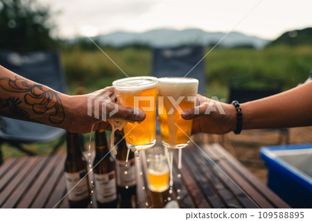 Beer on the table and camping party,hands toasting in beer, 109588895