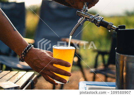 Beer on the table and camping party,hands toasting in beer, Beer on the table and camping party,hands toasting in beer, 109588907