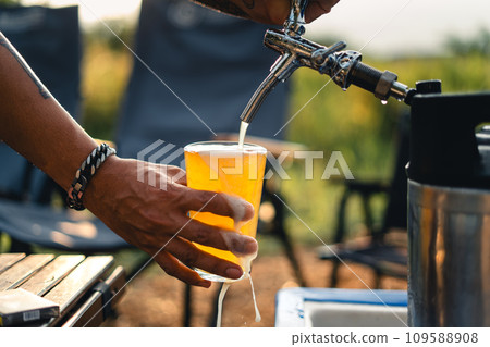 Beer on the table and camping party,hands toasting in beer, Beer on the table and camping party,hands toasting in beer, 109588908
