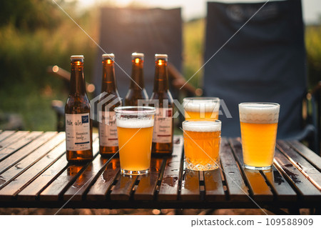 Beer on the table and camping party,hands toasting in beer, Beer on the table and camping party,hands toasting in beer, 109588909
