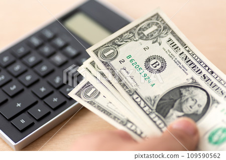 black calculator and one dollar bill black calculator and one dollar bill 109590562