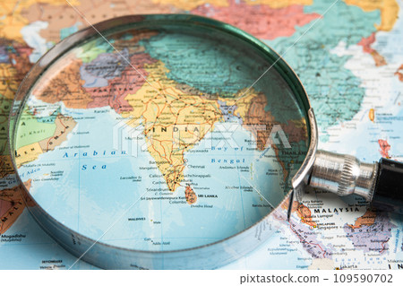 Bangkok, Thailand  January 20, 2022 India, Magnifying glass close up with colorful world map, travel, geography, tourism and exploration concept. 109590702