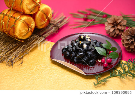 Traditional Japanese New Year dish, black beans, served with gold leaf Traditional Japanese New Year dish, black beans, served with gold leaf 109590995