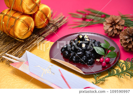 Traditional Japanese New Year dish, black beans, served with gold leaf Traditional Japanese New Year dish, black beans, served with gold leaf 109590997