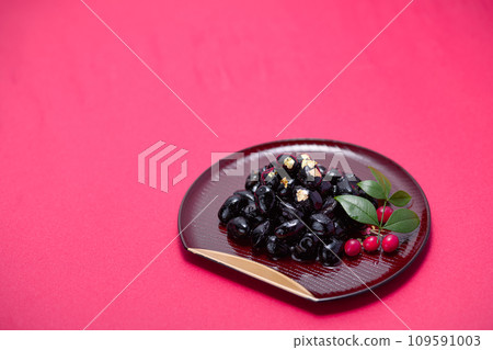 Traditional Japanese New Year dish, black beans, served with gold leaf Traditional Japanese New Year dish, black beans, served with gold leaf 109591003