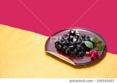 Traditional Japanese New Year dish, black beans, served with gold leaf Traditional Japanese New Year dish, black beans, served with gold leaf 109591007