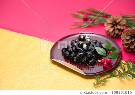 Traditional Japanese New Year dish, black beans, served with gold leaf Traditional Japanese New Year dish, black beans, served with gold leaf 109591010