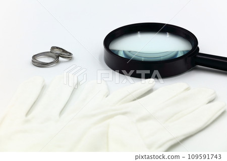 Image of magnifying glass, gloves, and appraisal 109591743