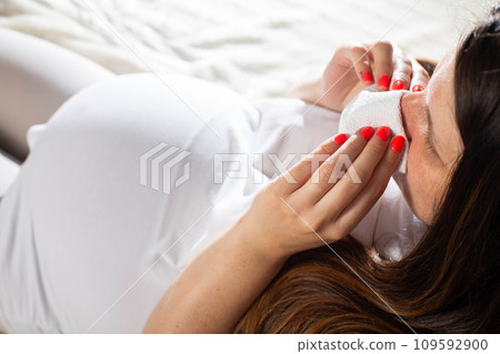 Nasal congestion and discharge of mucus from the nose in pregnant women. Rhinitis of pregnancy due to changes in hormone levels. Close-up 109592900