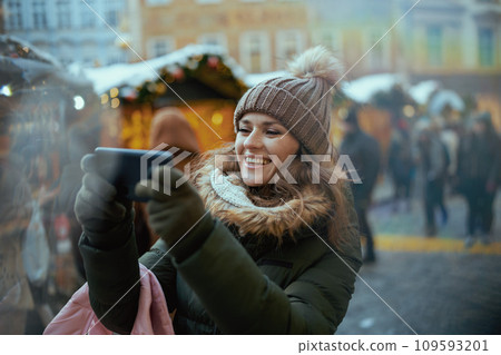 happy modern woman at christmas fair in city using video chat 109593201