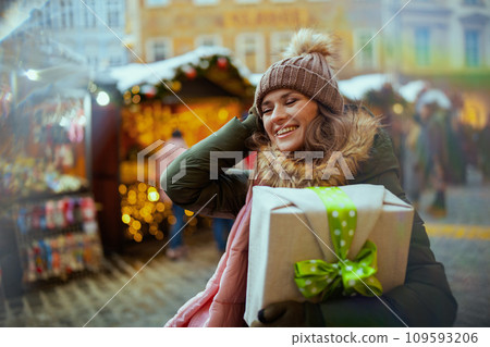 happy young woman at christmas fair in city 109593206