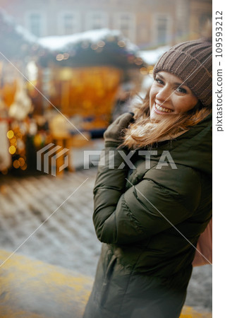 smiling modern 40 years old woman at winter fair in city smiling modern 40 years old woman at winter fair in city 109593212