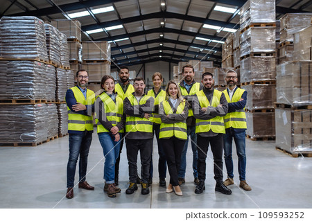 Full team of warehouse employees standing in warehouse. Team of workers, managers, female director in modern industrial factory, heavy industry, manufactrury. 109593252