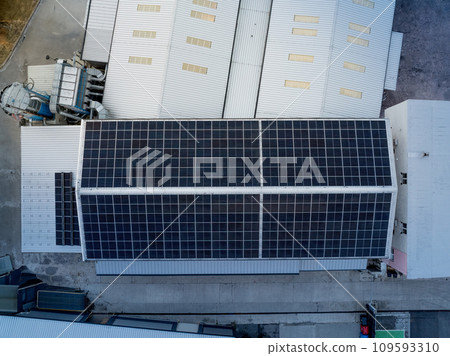 Aerial view of solar panels on a rooftop of factory. Solar energy as renewable energy source in business. Aerial view of solar panels on a rooftop of factory. Solar energy as renewable energy source in business. 109593310
