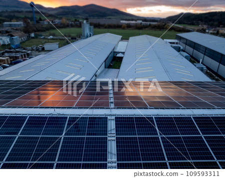 Aerial view of solar panels on a rooftop of factory. Solar energy as renewable energy source in business. 109593311