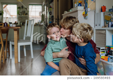 Father hugging and kissing son's cheeks. Concept of Father's Day, and fatherly love. 109593493