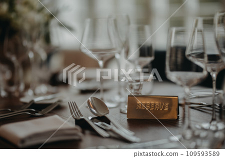 Reservation on table, reserved table sign, plate. Elegant, romantic table setting for indoor wedding reception. or for restaurant. 109593589