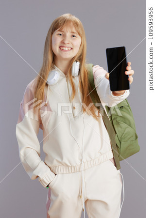 happy modern school girl showing smartphone blank screen 109593956
