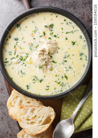 Ciorba radauteana Romanian traditional sour chicken soup closeup on the plate. Vertical top view 109594016