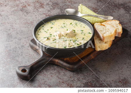 Ciorba Radauteana is a traditional Romanian soup made with a chicken, onions, sweet red pepper, celery, carrots, garlic, parsley, and sour cream closeup on the plate. Horizontal Ciorba Radauteana is a traditional Romanian soup made with a chicken, onions, sweet red pepper, celery, carrots, garlic, parsley, and sour cream closeup on the plate. Horizontal 109594017
