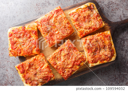 Sfincione pizza with onions, tomatoes, cheese, anchovies and breadcrumbs closeup on the wooden board. Horizontal top view Sfincione pizza with onions, tomatoes, cheese, anchovies and breadcrumbs closeup on the wooden board. Horizontal top view 109594032