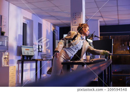Executive manager preparing to leave startup office late at night, after working overtime at financial investment strategy to increase company profit. Businesswoman leaving corporate job 109594548
