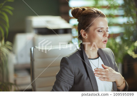 business woman in modern green office doing breathing exercises business woman in modern green office doing breathing exercises 109595099