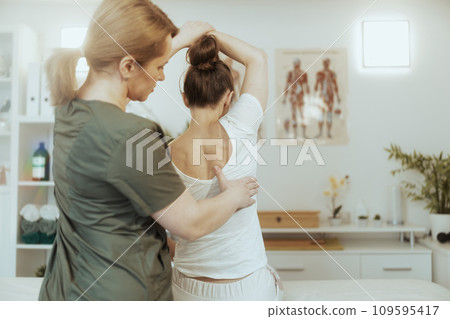 massage therapist woman in massage cabinet doing checkup massage therapist woman in massage cabinet doing checkup 109595417