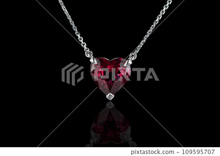 beautiful pendant with garnet with a gold chain on a black background 109595707