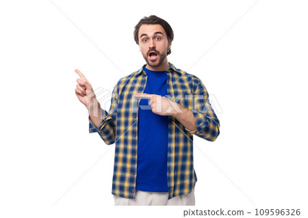 young stylish handsome caucasian brunette with a beard is dressed in a blue plaid shirt and t-shirt young stylish handsome caucasian brunette with a beard is dressed in a blue plaid shirt and t-shirt 109596326
