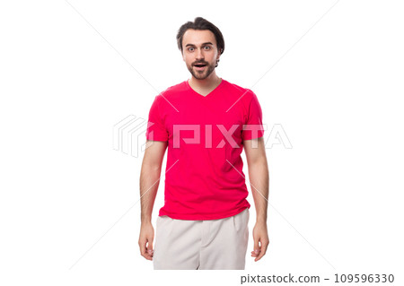 young pleasant slender brunette man with a cool hairstyle is dressed in a red t-shirt 109596330