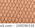 Texture of knitted woolen fabric for wallpaper toned with peach fuzz color of the year 2024 109596338