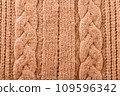 Knitted texture toned with color of the year 2024 peach fuzz 109596342