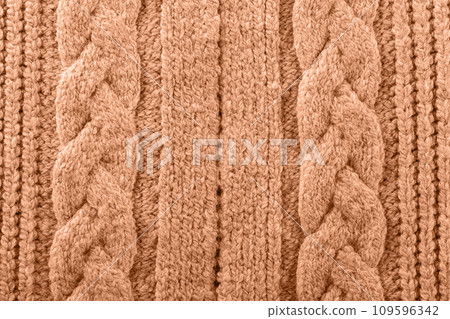 Knitted texture toned with color of the year 2024 peach fuzz Knitted texture toned with color of the year 2024 peach fuzz 109596342
