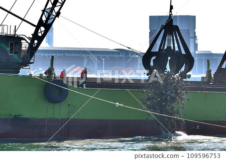 Offshore seawall construction - foundation rubble stone installation work 109596753