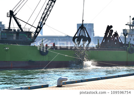 Offshore seawall construction - foundation rubble stone installation work Offshore seawall construction - foundation rubble stone installation work 109596754