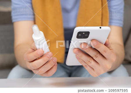 Woman reading instructions for the use of medication on the Internet using a smartphone. Online appointment with a doctor. 109597595