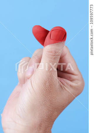 man doing the finger heart gesture 109597773