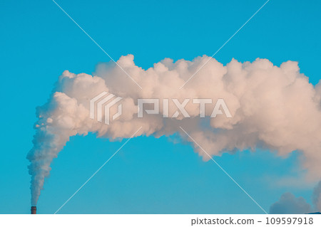 Smoke from chimney against blue sky. Ecological problem. Release of carbon dioxide into atmosphere. 109597918