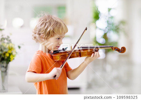 Child playing violin. Remote learning. Child playing violin. Remote learning. 109598325