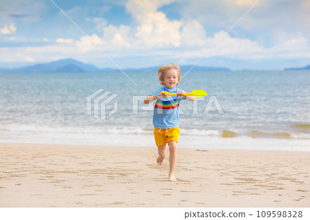 Kids play on tropical beach. Sand and water toy. Kids play on tropical beach. Sand and water toy. 109598328